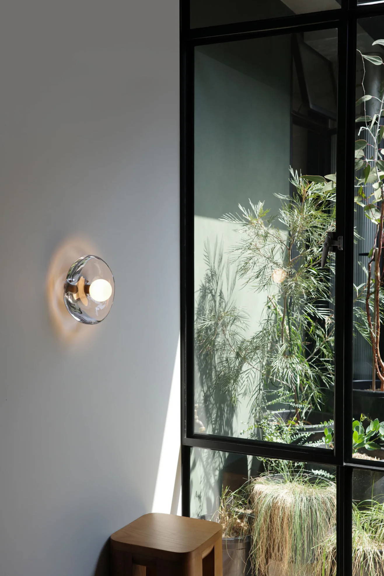 Handmade Clear Glass Wall Light on a plain background light on 