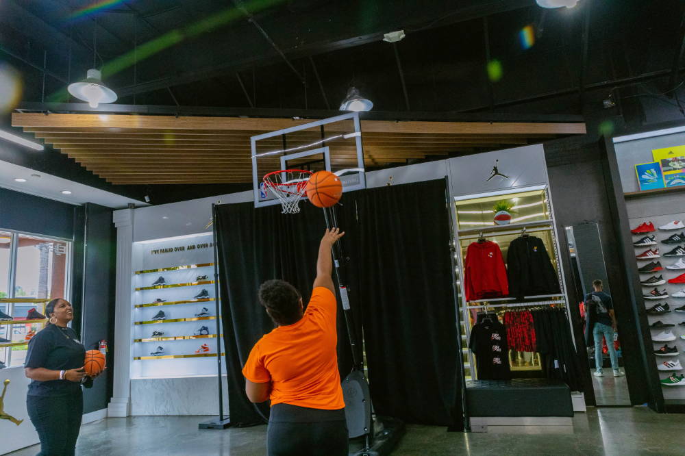 girl shooting basketball at for her event