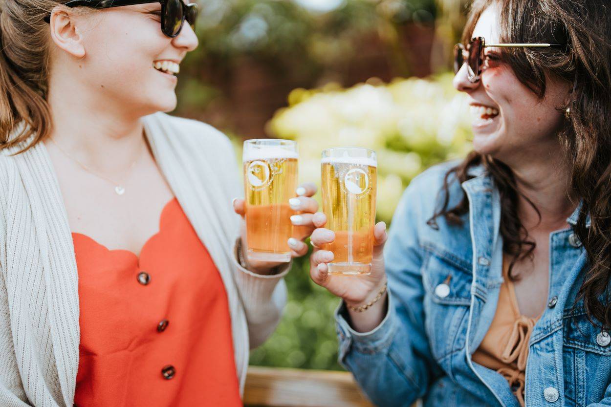 Can you get drunk on non alcoholic beer? Two young women  holding Small Beer glasses 