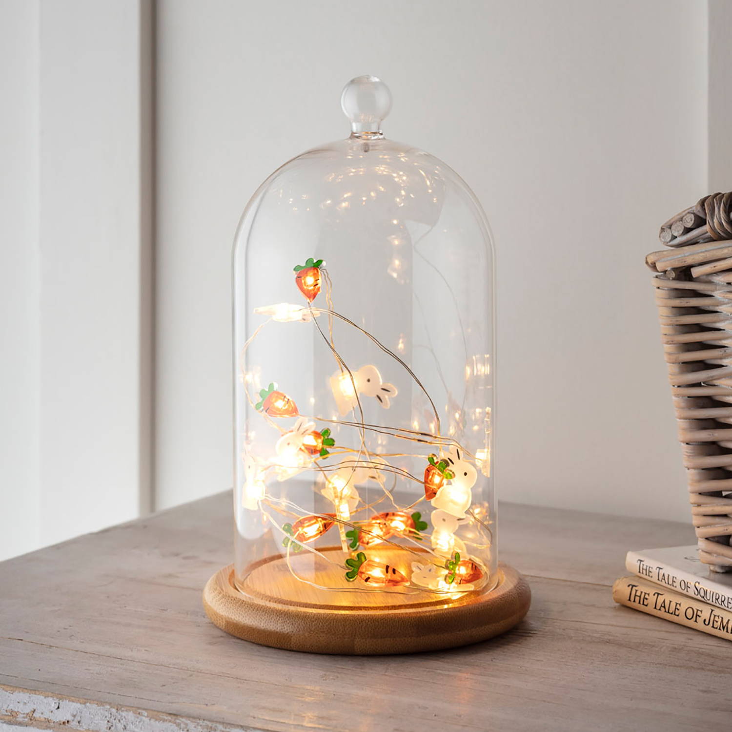 Bunny and carrot micro lights displayed in bell jar and illuminated 