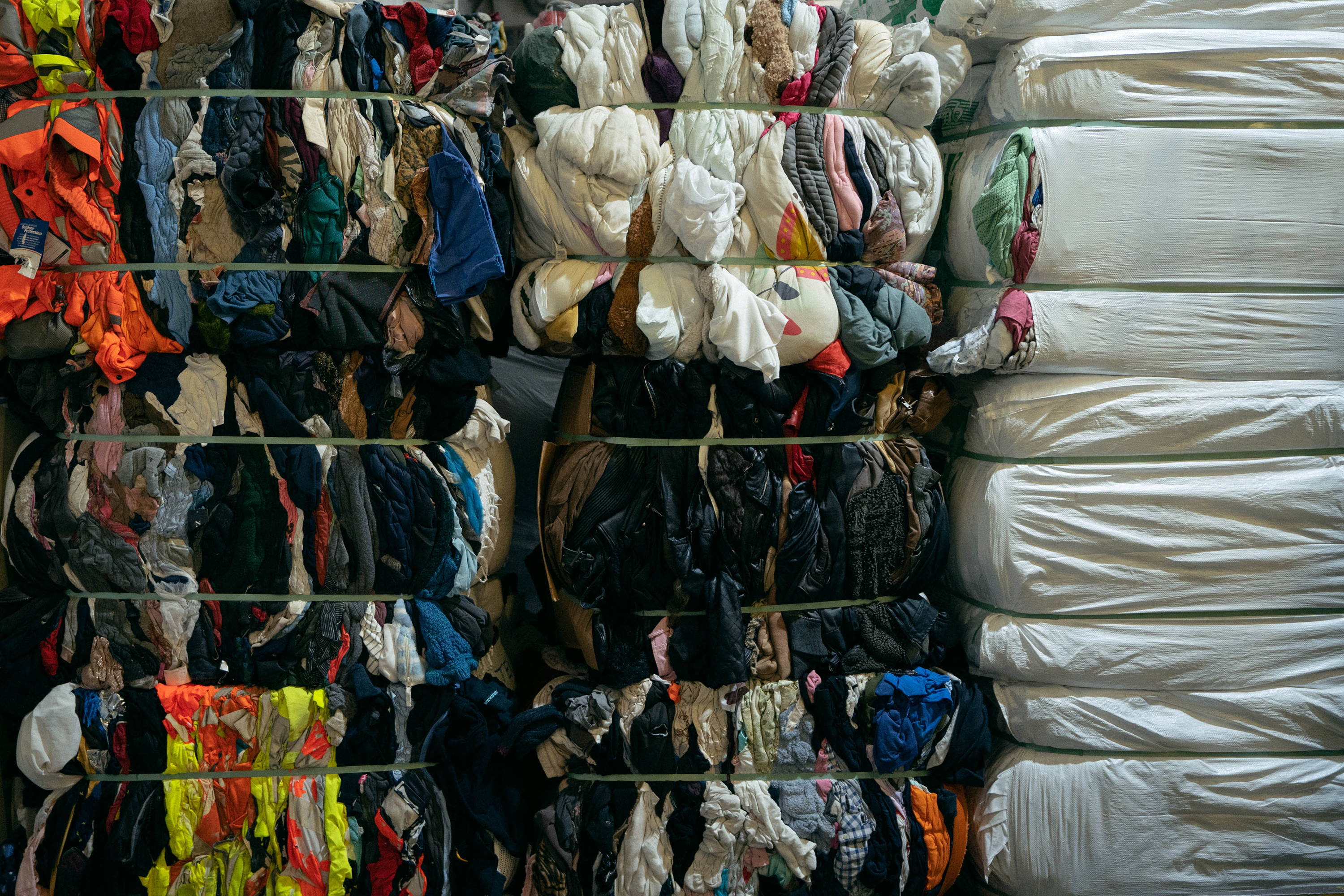 Bales of pre-loved clothes awaiting refurbishment, repair and recycling.