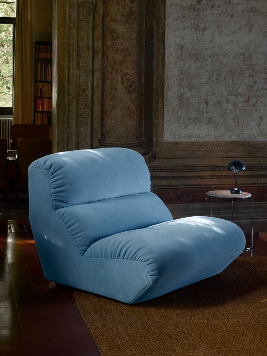 A blue, Hi Lo lounge chair by &tradition in a stylish interior setting.