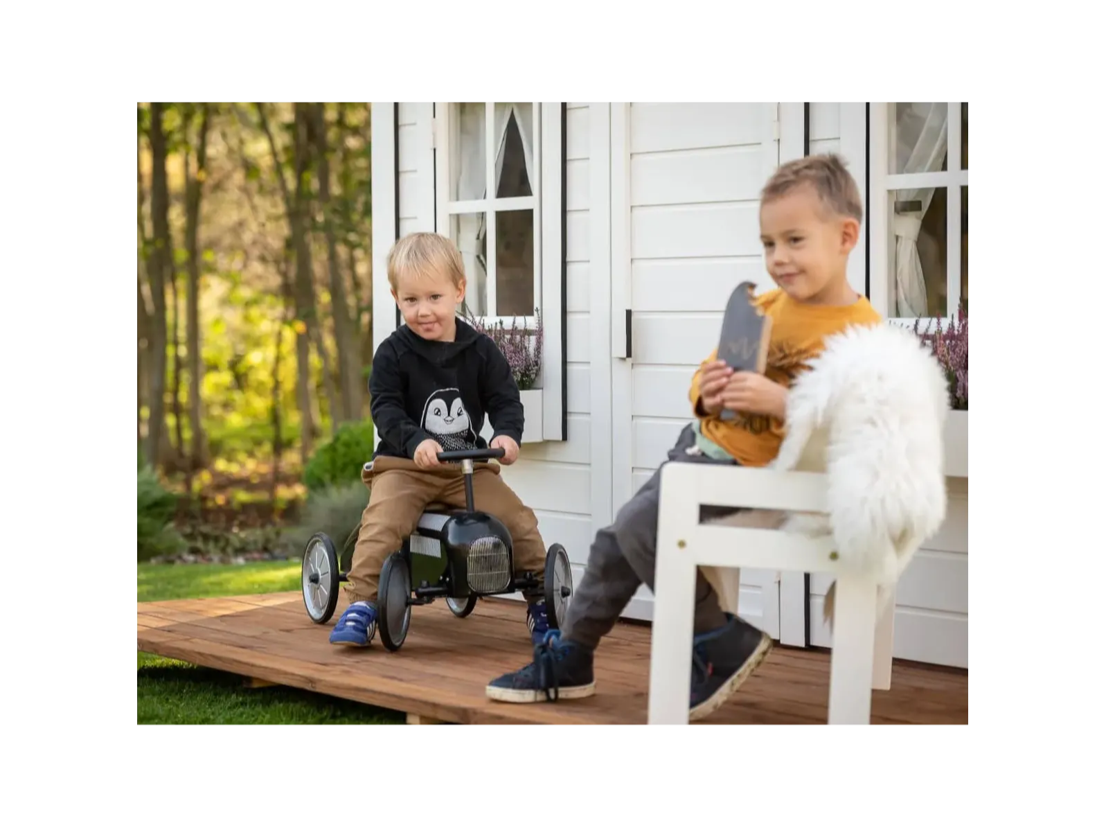 Two boys playing in front of outdoor playhouse Arctic Nario