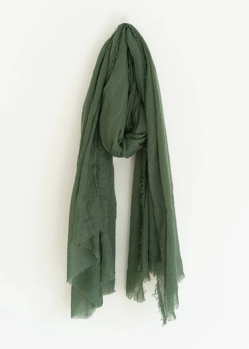 A khaki green scarf with haw hem detailing