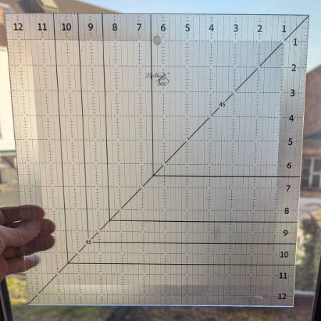Showing the non-slip layer of the square-up ruler holding it in front of a window