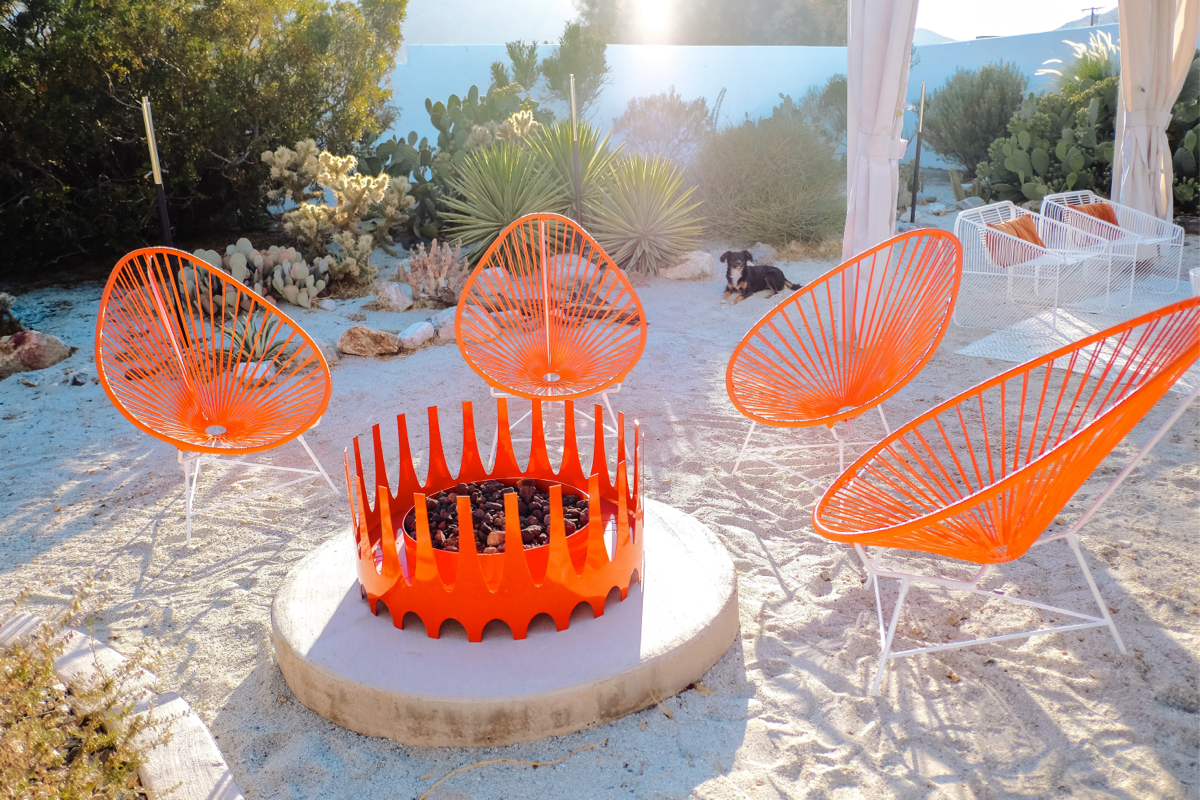 Bohxill royal fire pit with acapulco chairs in a sunny desert backyard