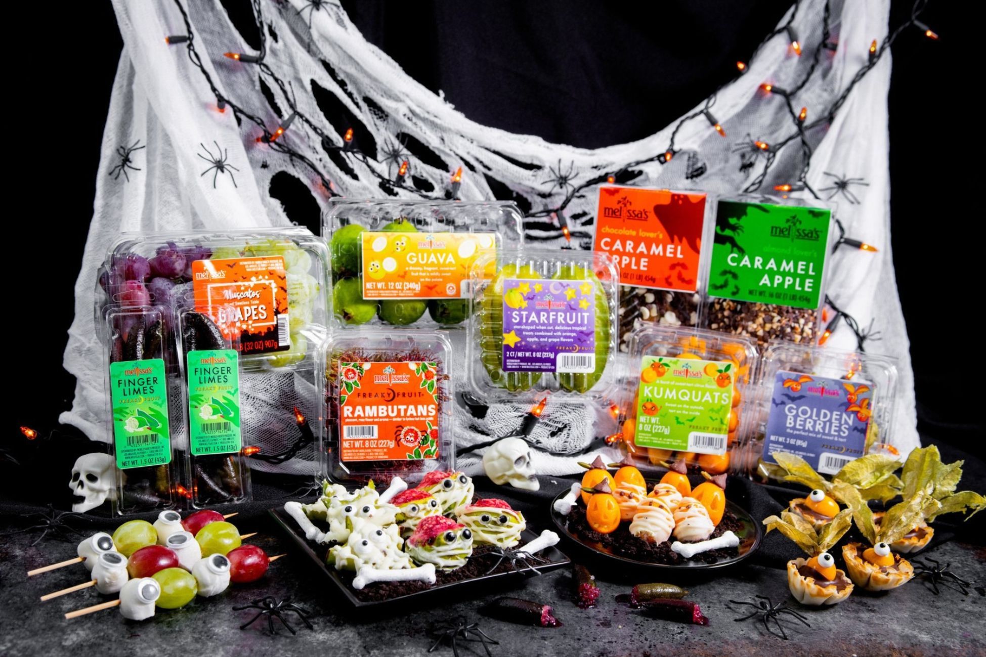 A variety of packaged snacks displayed with Halloween decorations.
