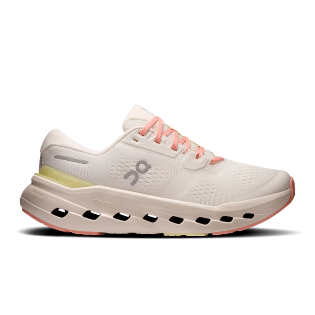 White running shoe with pink laces and detailing, featuring a cushioned sole.