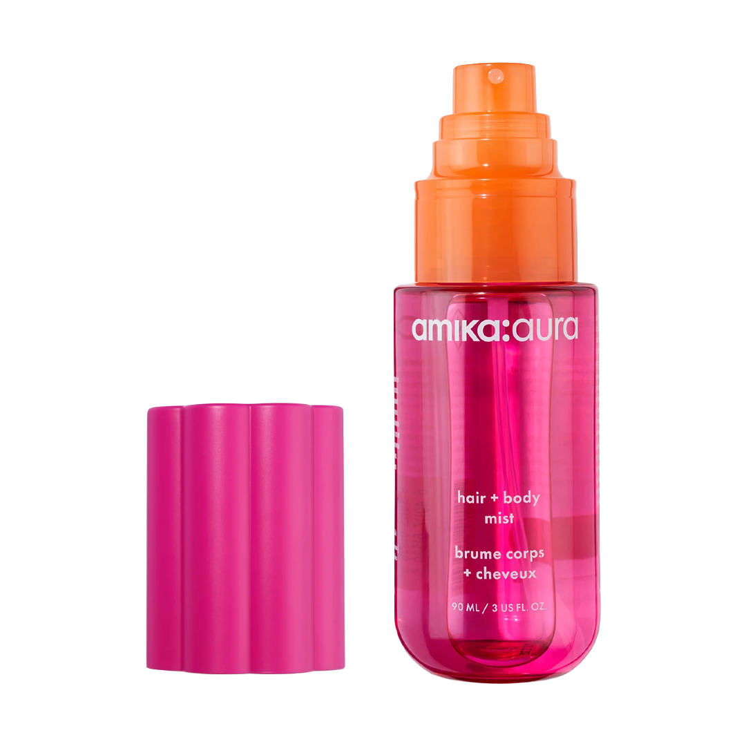 A pink and orange bottle of hair and body oil with a cap.