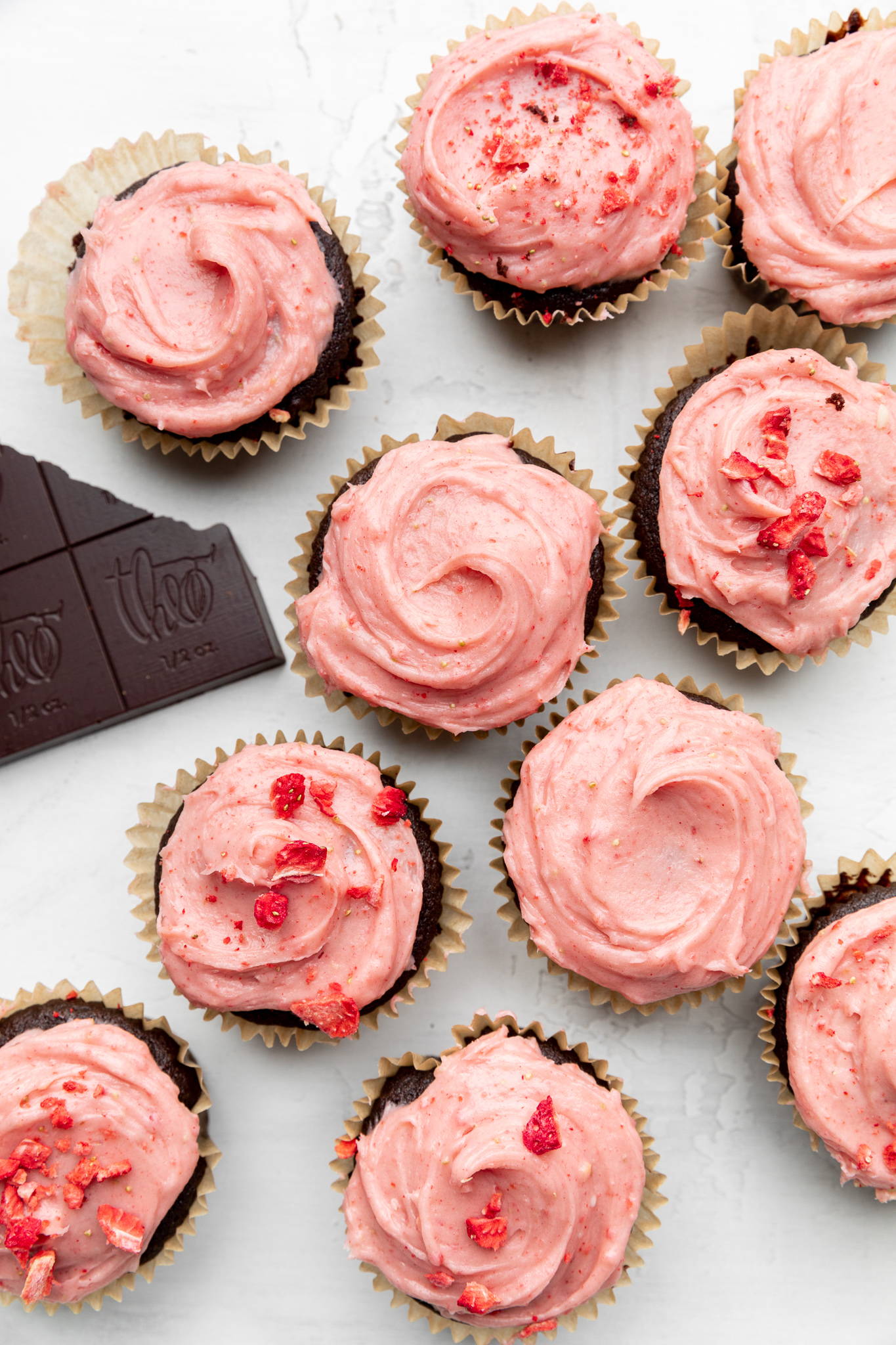 Chocolate cupcakes topped with strawberry cream cheese frosting and freeze dried strawberries.