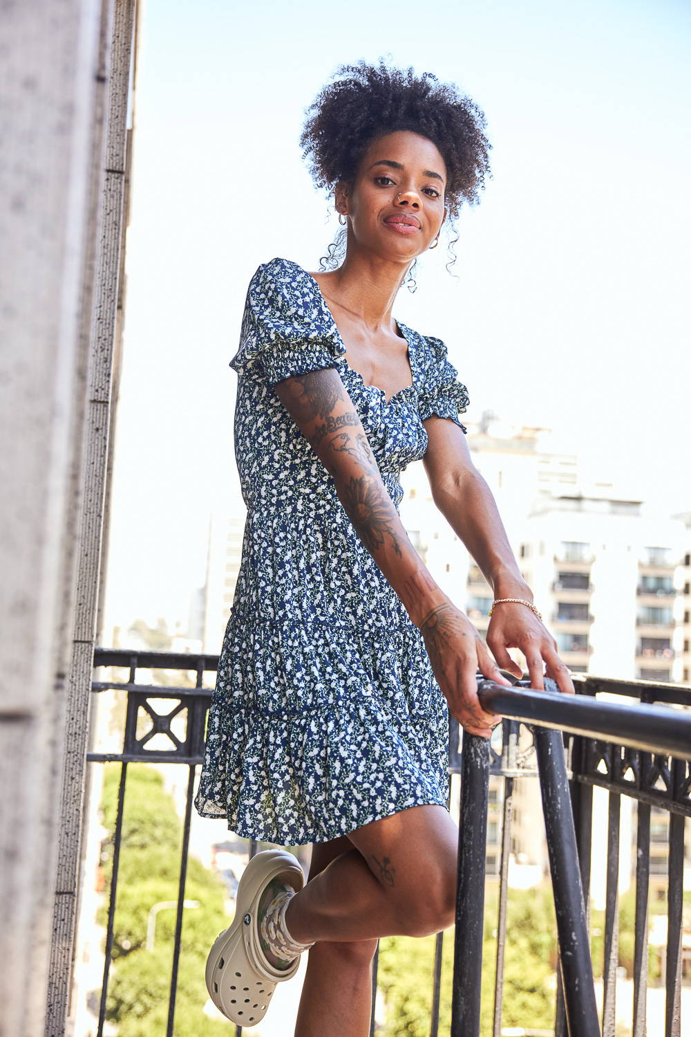 Trixxi Back to school embracing dorm life hanging out on the balcony in a navy with white flowers tier dress.
