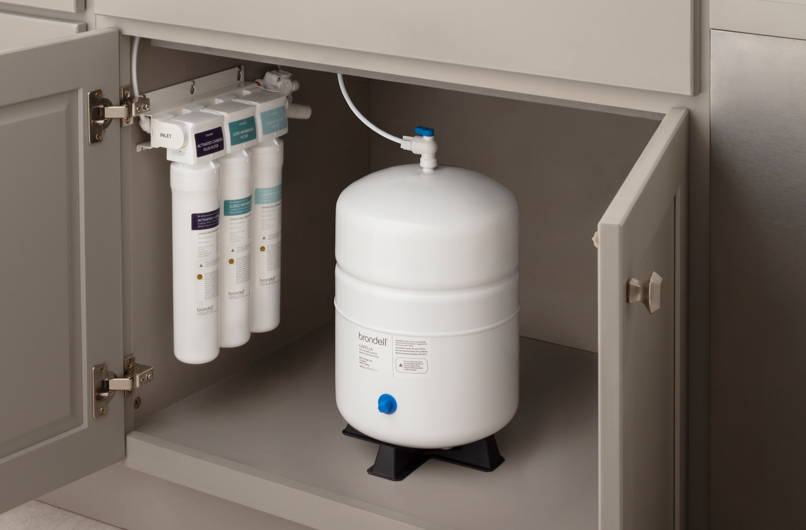 Brondell Capella Reverse Osmosis Under Sink Water Filtration System installed in taupe grey shaker cabinet.
