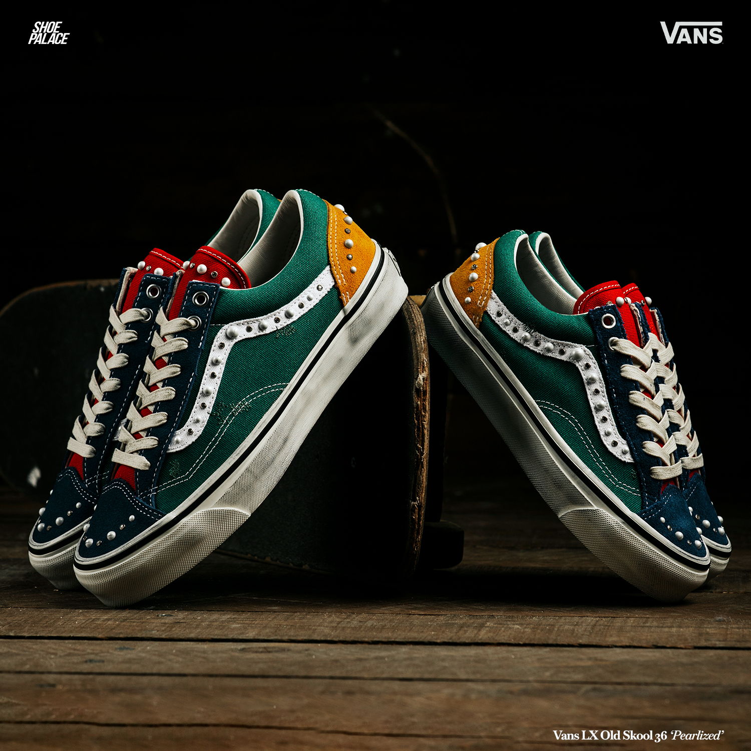 Colorful Vans sneakers displayed on a wooden surface with dark background.