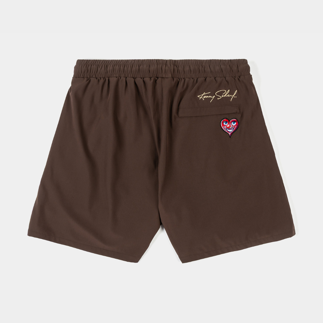 Brown shorts with drawstring and decorative patches.