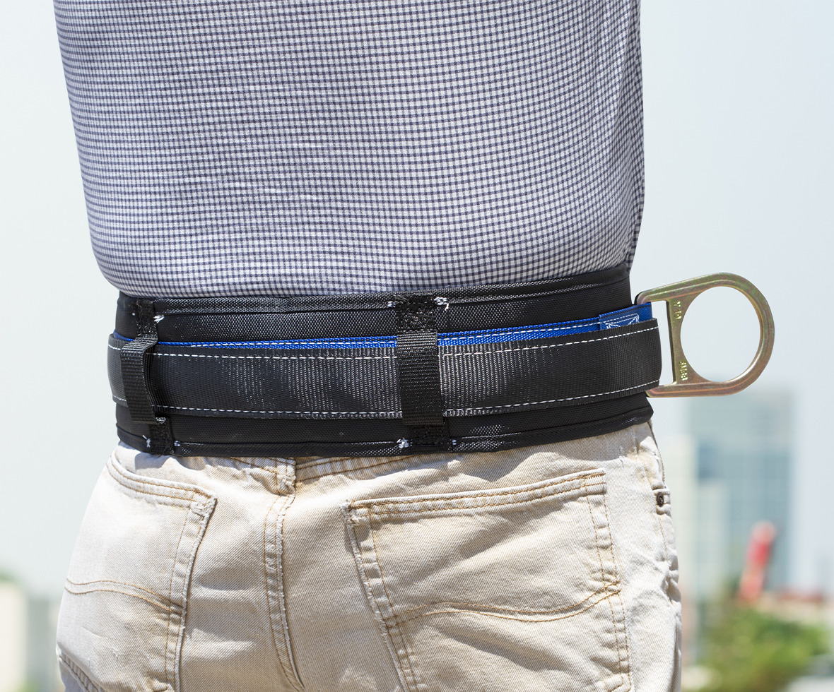 Construction worker overlooking skyline wearing a body belt