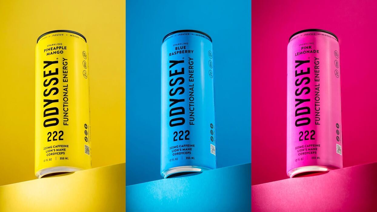 Three colorful beverage cans on a vibrant background.