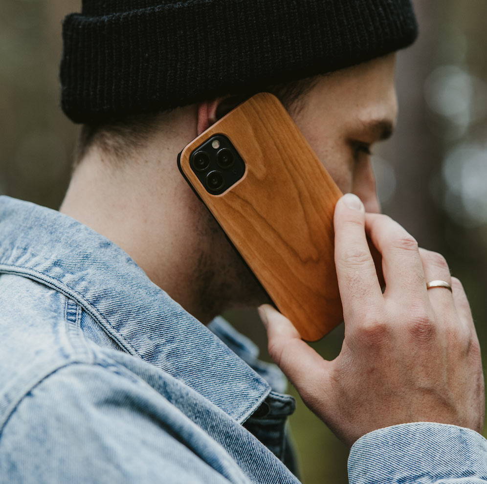 man talking phone wooden case