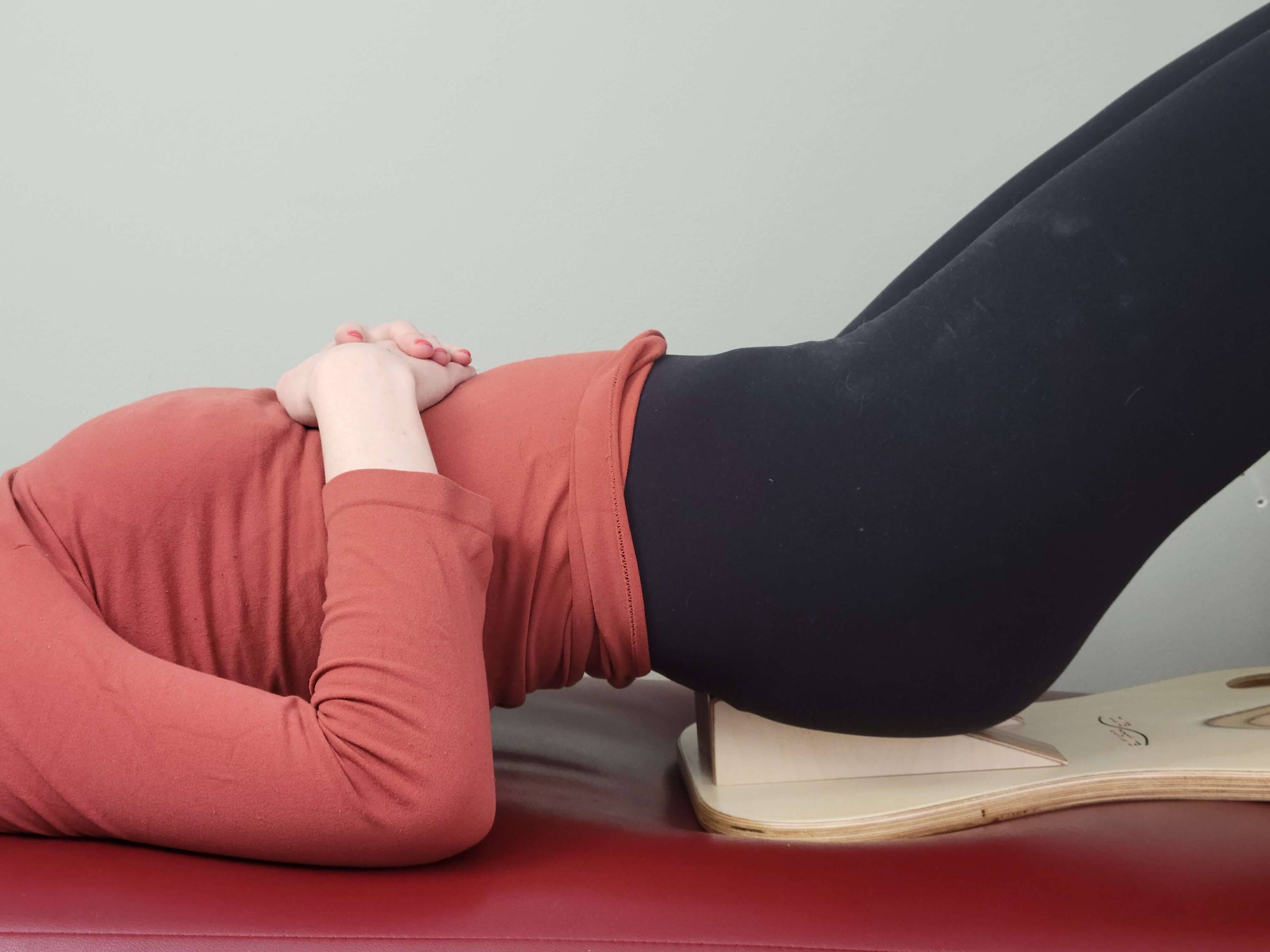 woman laying on PurePosture board sacrum