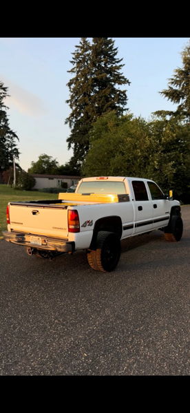 Rear three-quarter sunset view of Owen's white 2001 Chevy Silverado 2500HD with toolbox and black wheels, install photo 2
