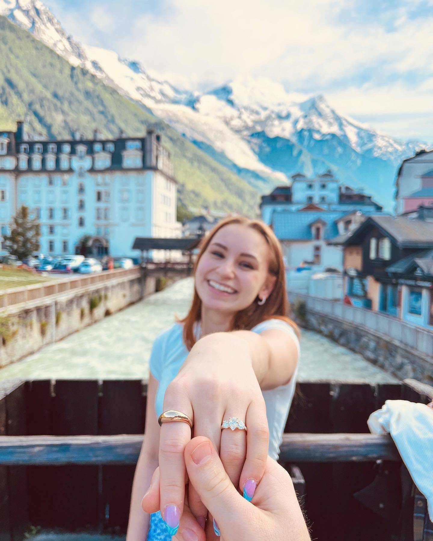 Mackenzie holding out her hand with the engagement ring