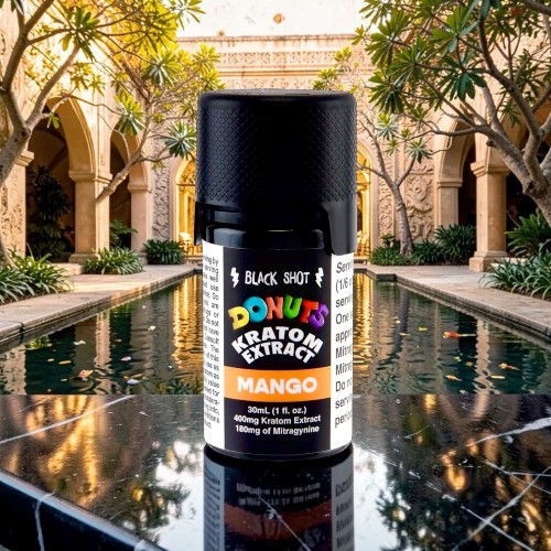Bottle of mango kratom extract with a garden background.