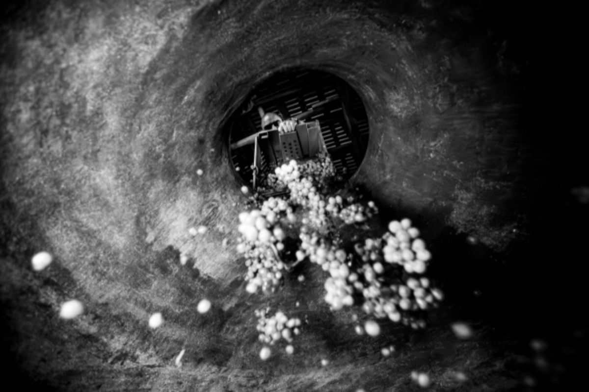 Aerial view of a dark tunnel with bubbles rising.