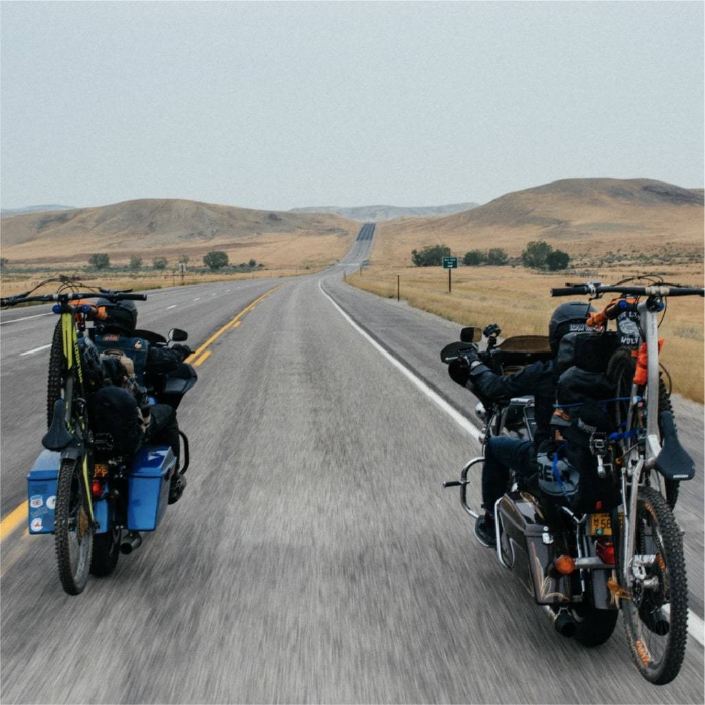 Two motorcycles with bikes attached
