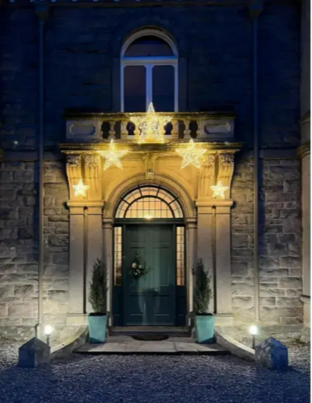 An entrance with LED star lights forming an arch.