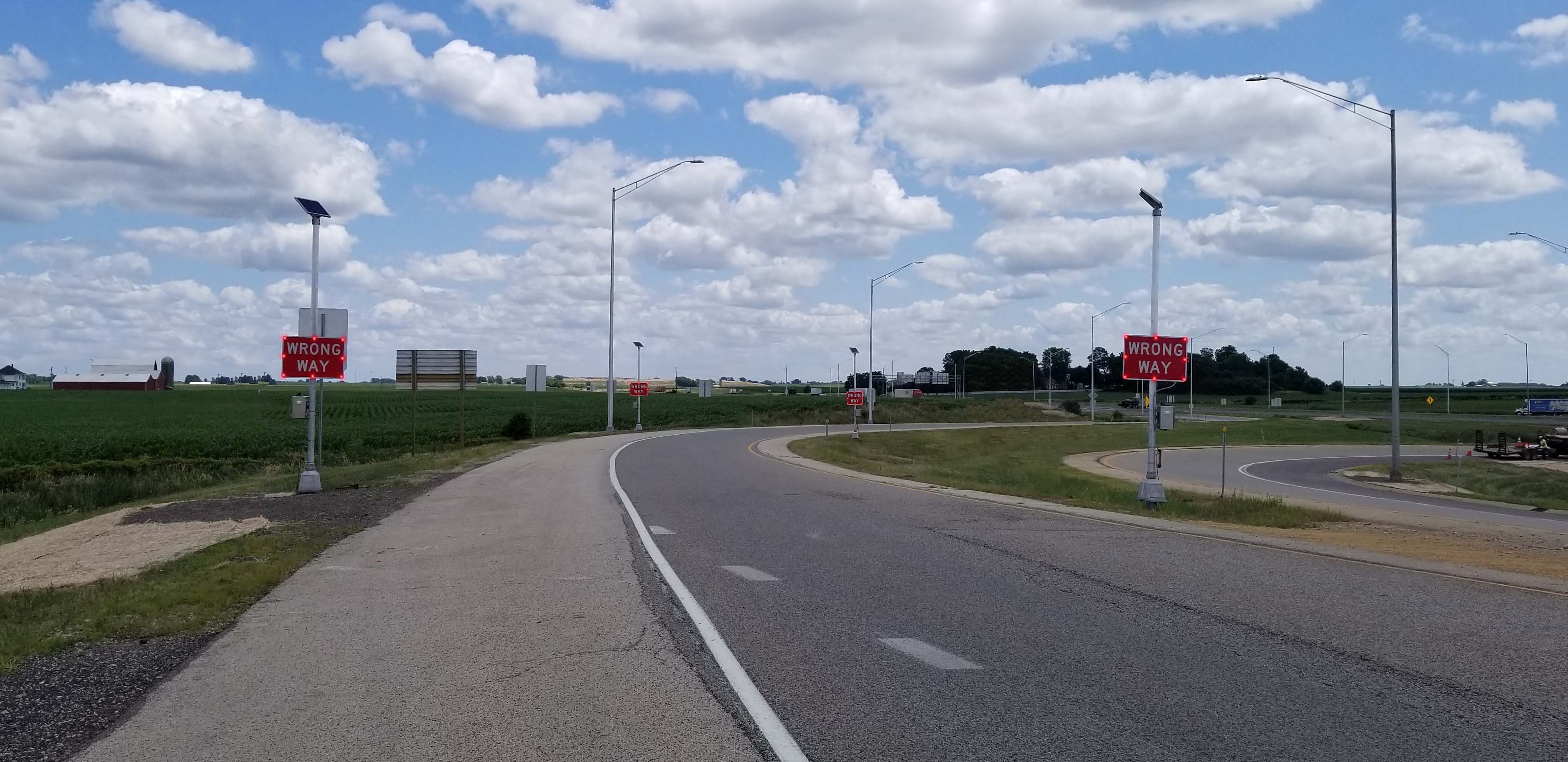 Wrong-way signs with LED enhancements on a highway off-ramp
