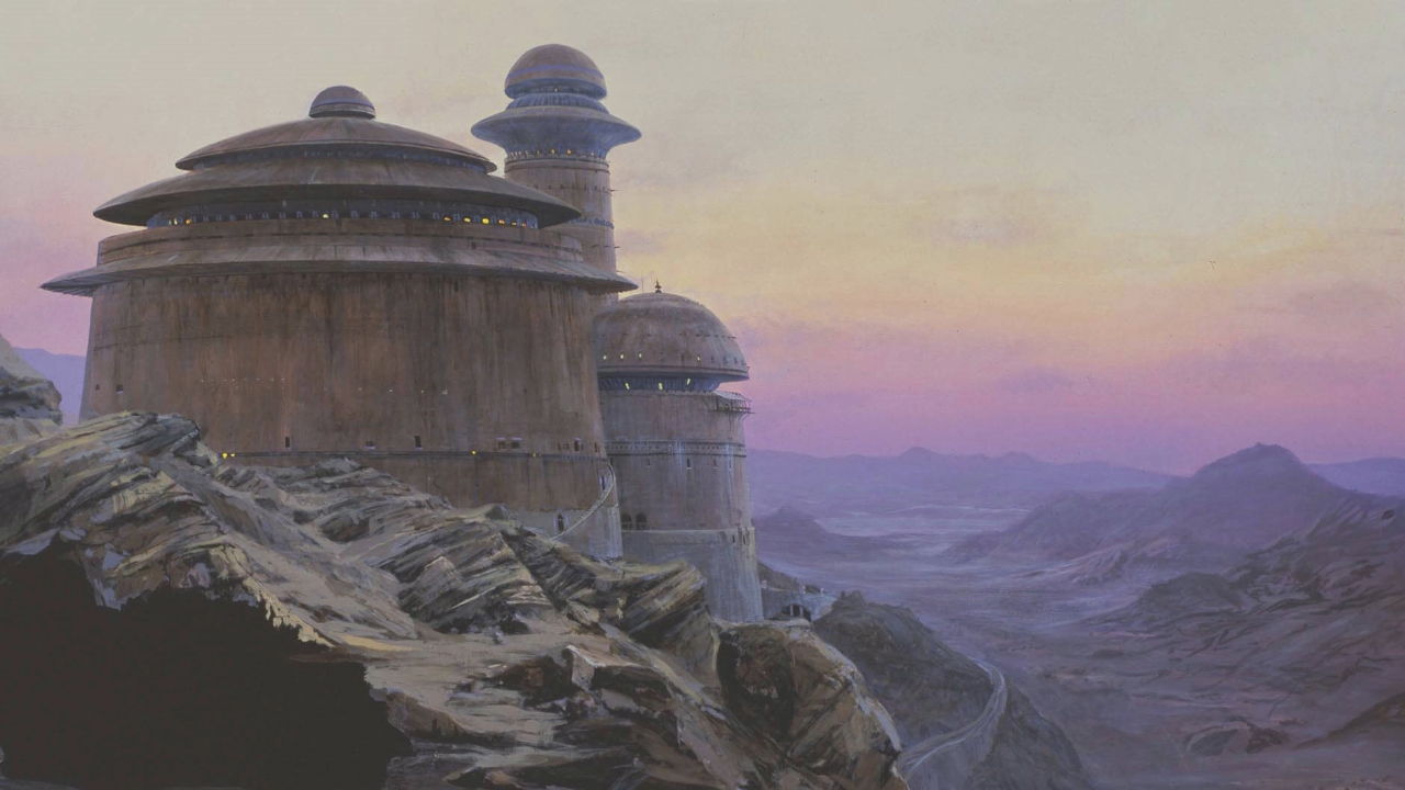 A rocky landscape with domed structures under a colorful sunset sky.
