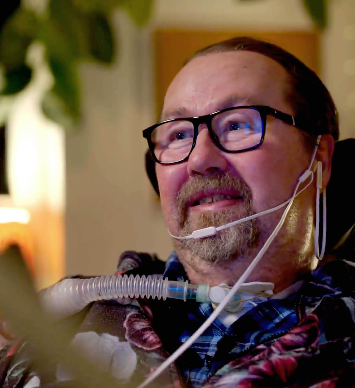 A man with ALS using a speech device to talk to his wife. 