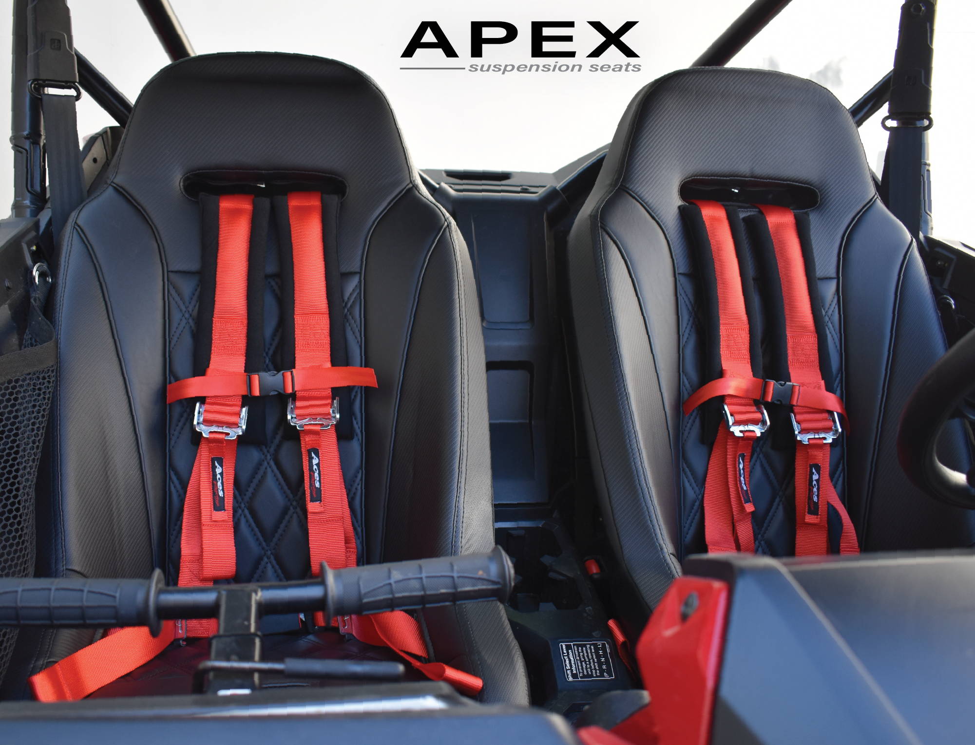 Black Apex suspension seats with red harnesses