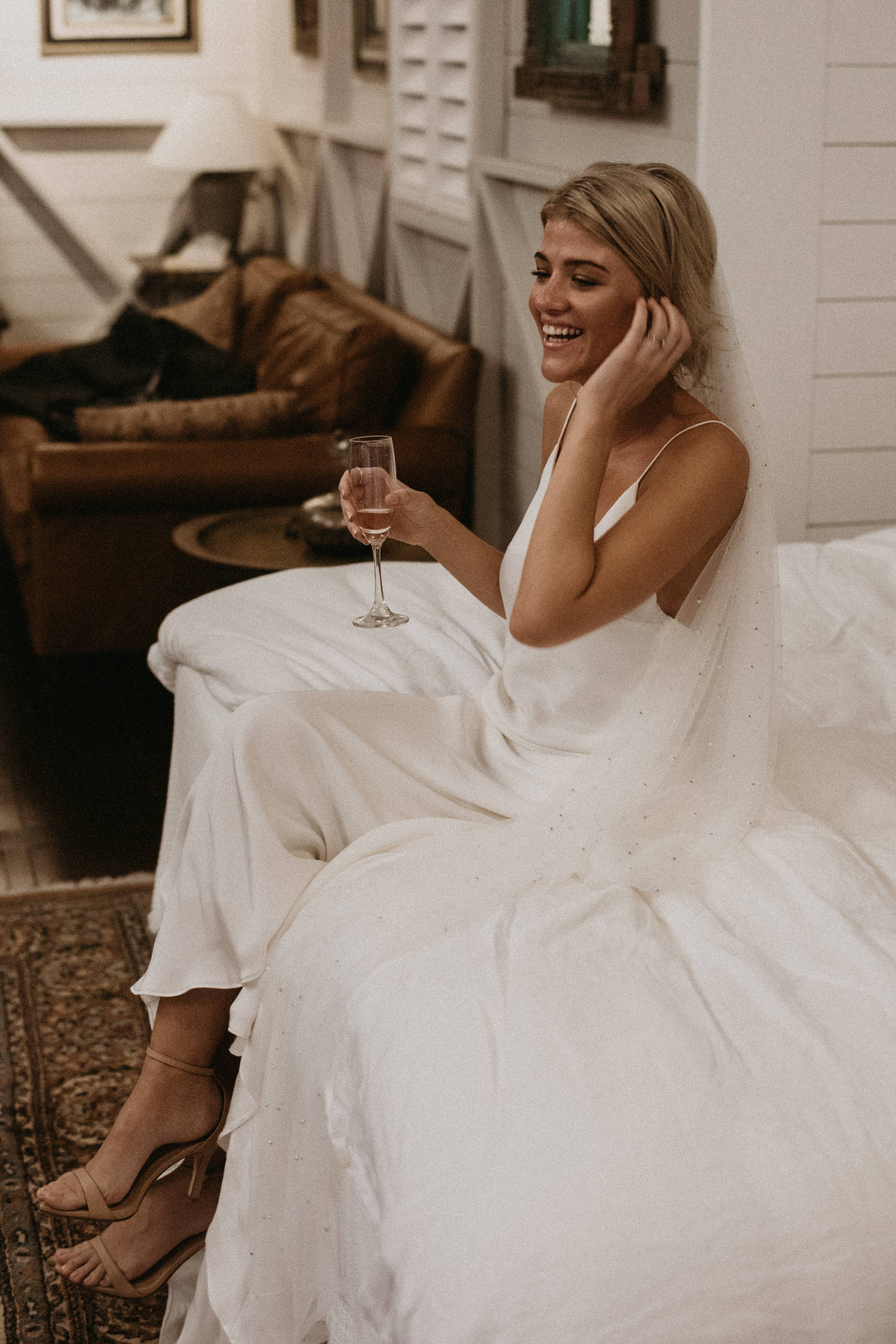 Grace Loves Lace bride wearing the Sand dosa heels sipping champagne 