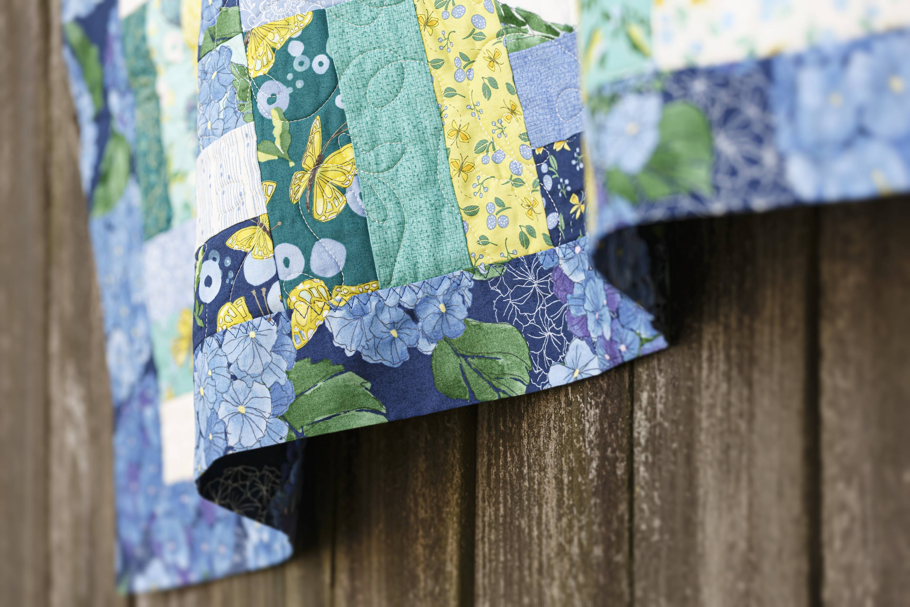 tips for quilting with wide backing fabric and making a self-binding quilt