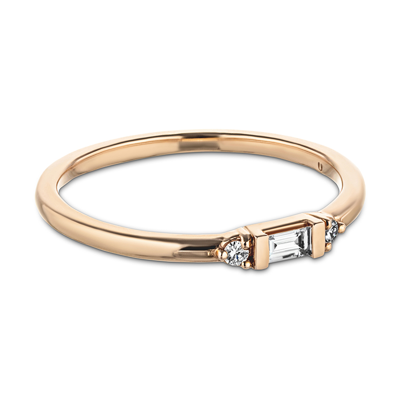 Stackable band with a baguette cut diamond and  two round diamonds surrounding