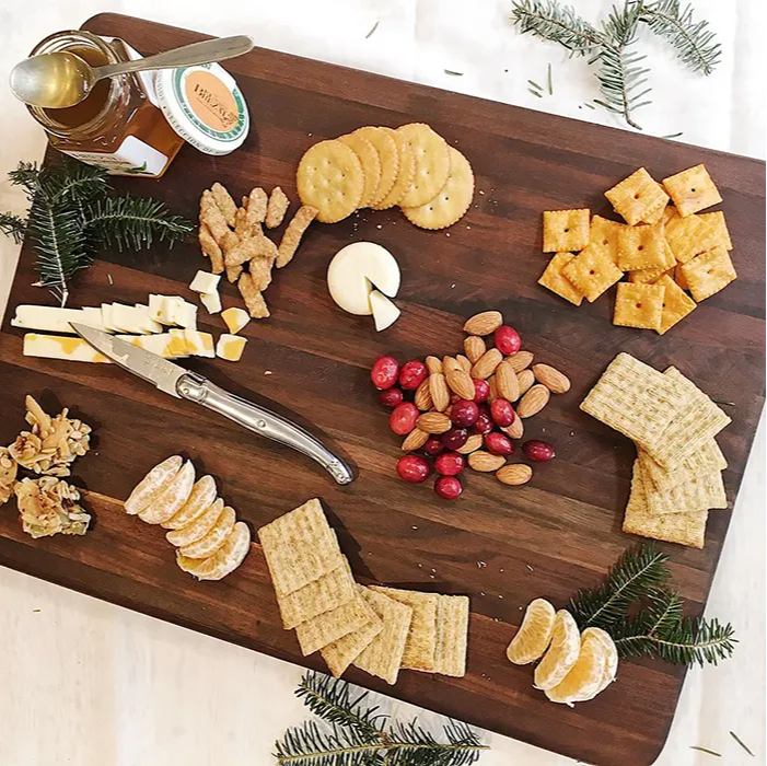 A variety of snacks on a wood serving tray 