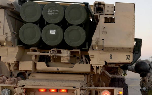 U.S. Army Soldiers from 1st Battalion, 14th Field Artillery, 214th Fires Brigade, Fort Sill, Okla., clean the mud off of a M142 High Mobility Artillery Rocket Systems vehicle before it is loaded onto a U.S. Air Force C-17 Globemaster III cargo aircraft, March 6, 2015. Cargo must be cleaned prior to loading to ensure safety and cleanliness in the aircraft, as well as keeping foreign object debris off the flight line and to protecting the transport of different soil types and rocks from one location to another. (U.S. Air Force photo by Airman 1st Class Nathan Clark/Released)