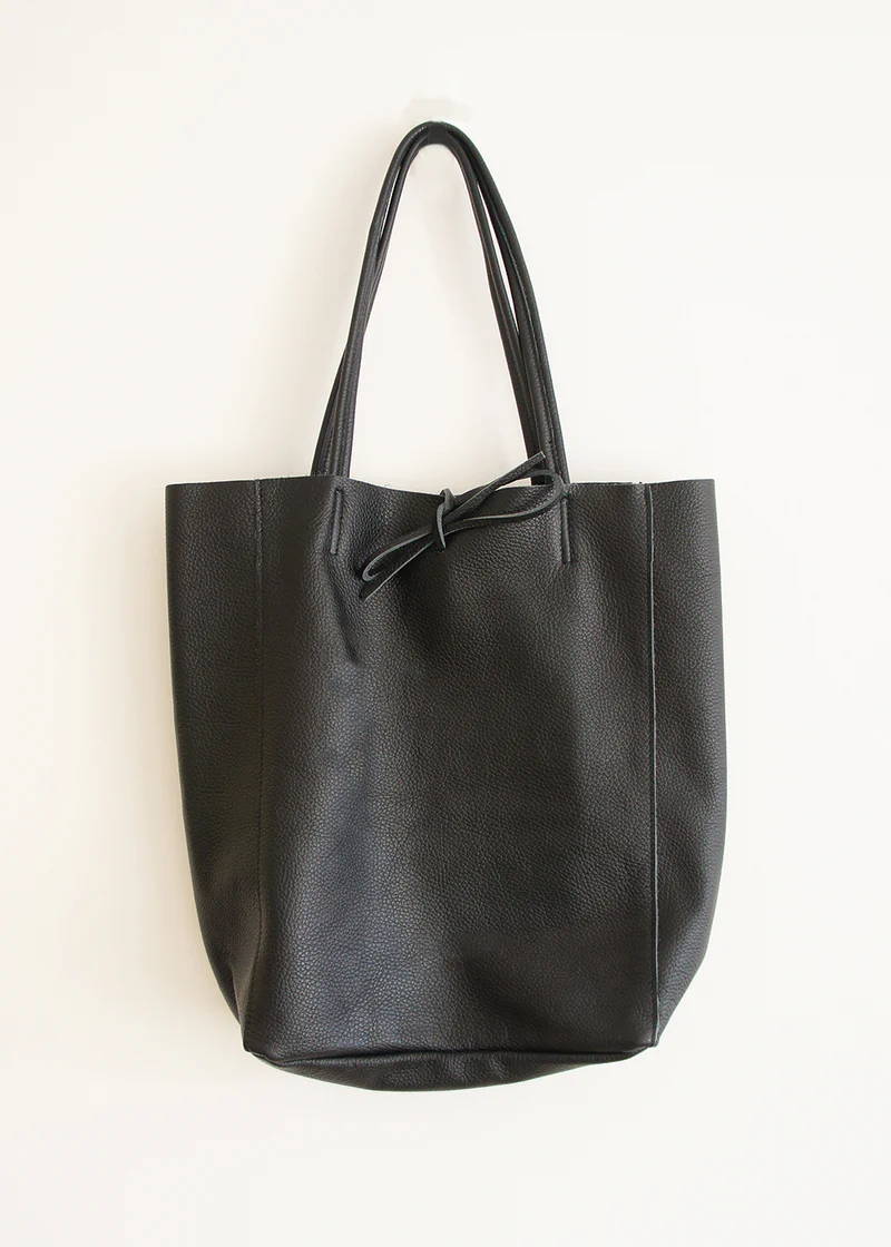 A metallic leather tote bag with tie string and shoulder strap