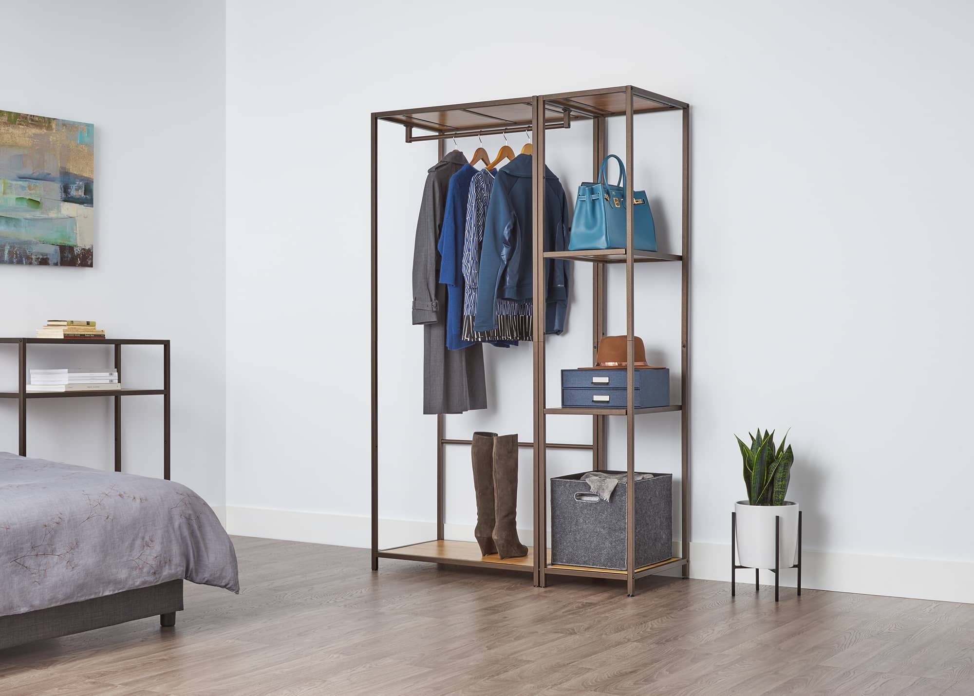 1 garment rack and 1 shelving tower as a closet organizer in an apartment room