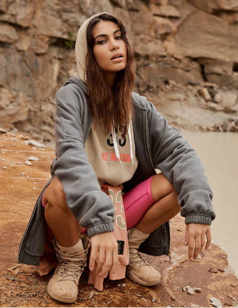 Girl sitting in a quarry wearing a cosy outfit