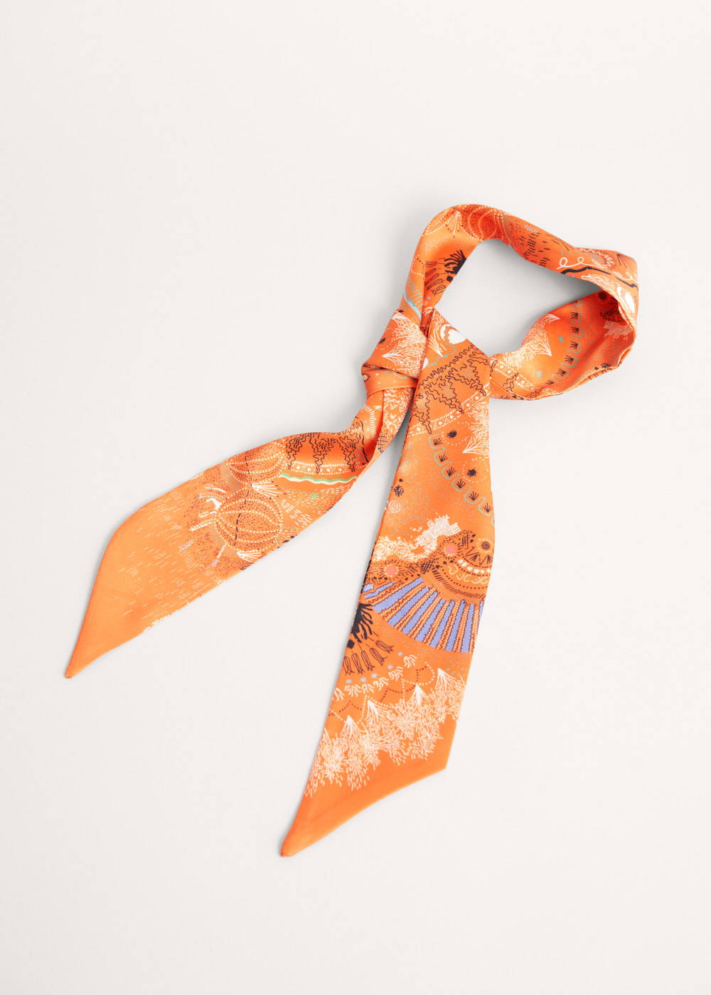 An orange satin neck scarf with a white and blue pattern