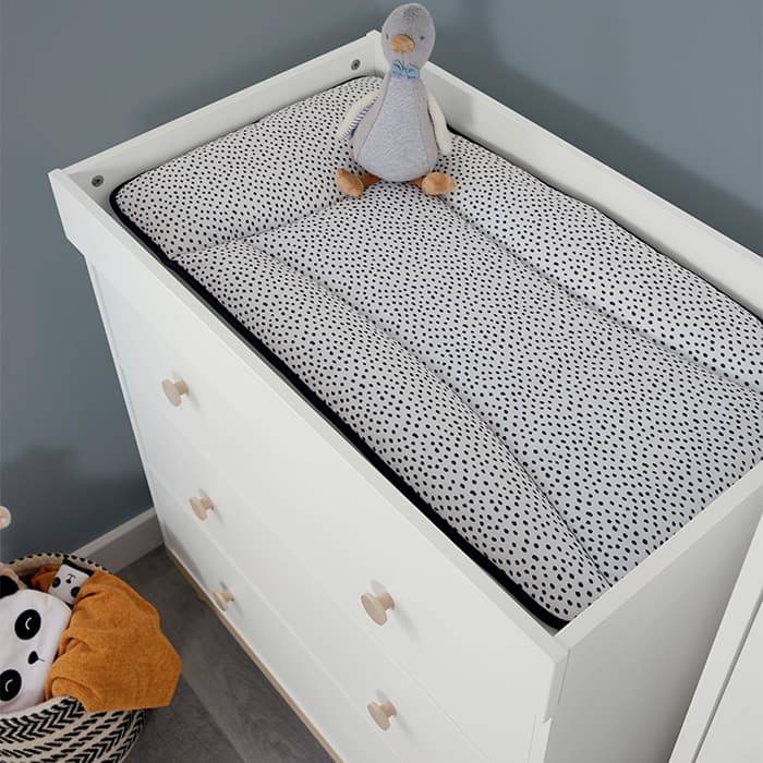 Essentials Baby Changing Mat - Mono Spot - Lifestyle image with white chest of draws and duck toy