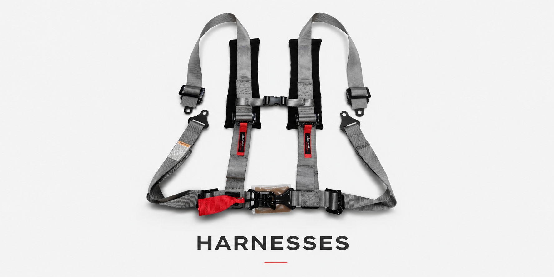 A grey harness with red accents displayed against a plain background.