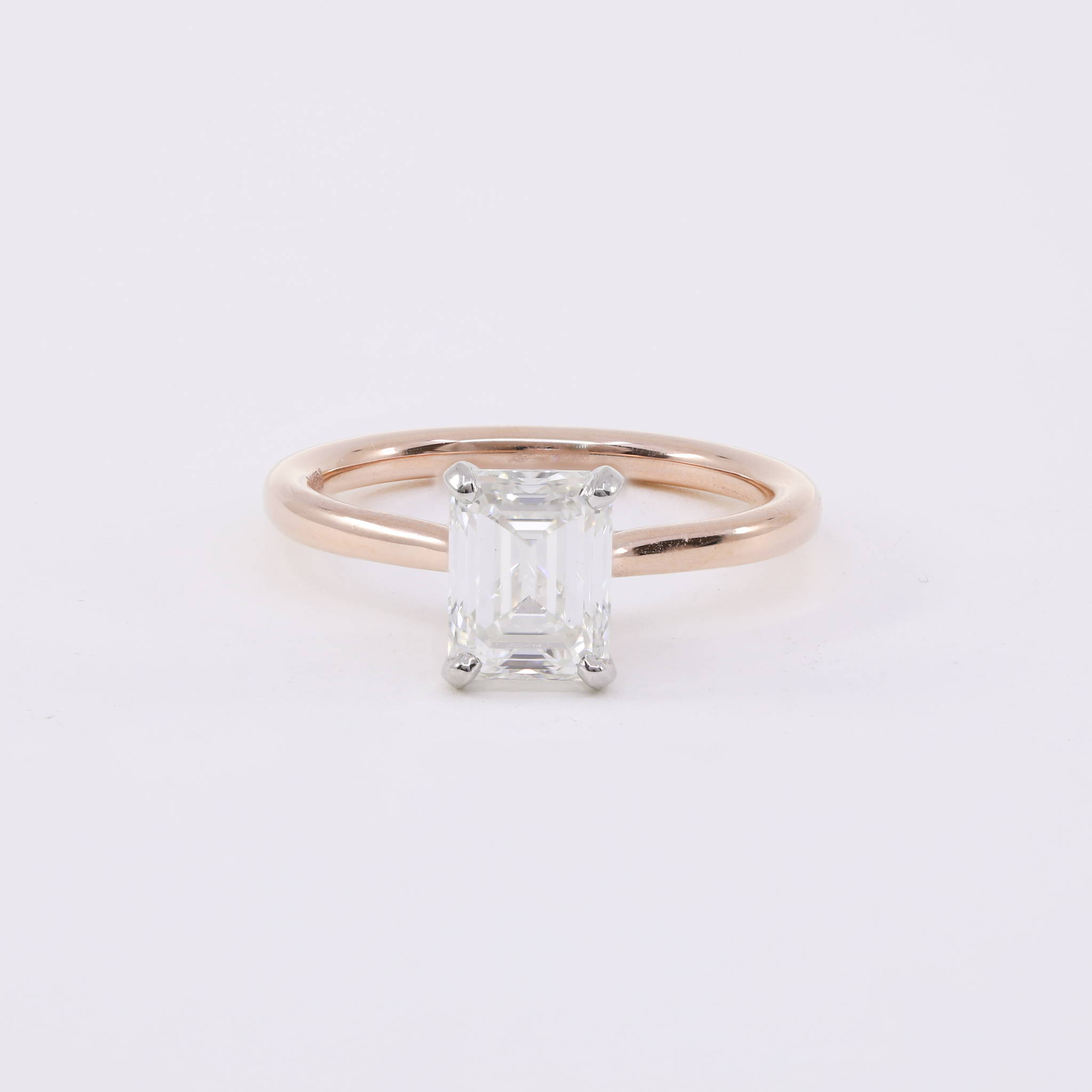 14k rose gold solitaire engagement ring with an emerald-cut diamond