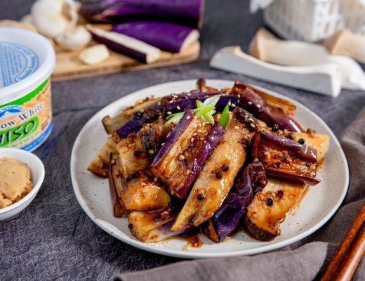 Plate of stir-fried eggplant with garlic and spices.