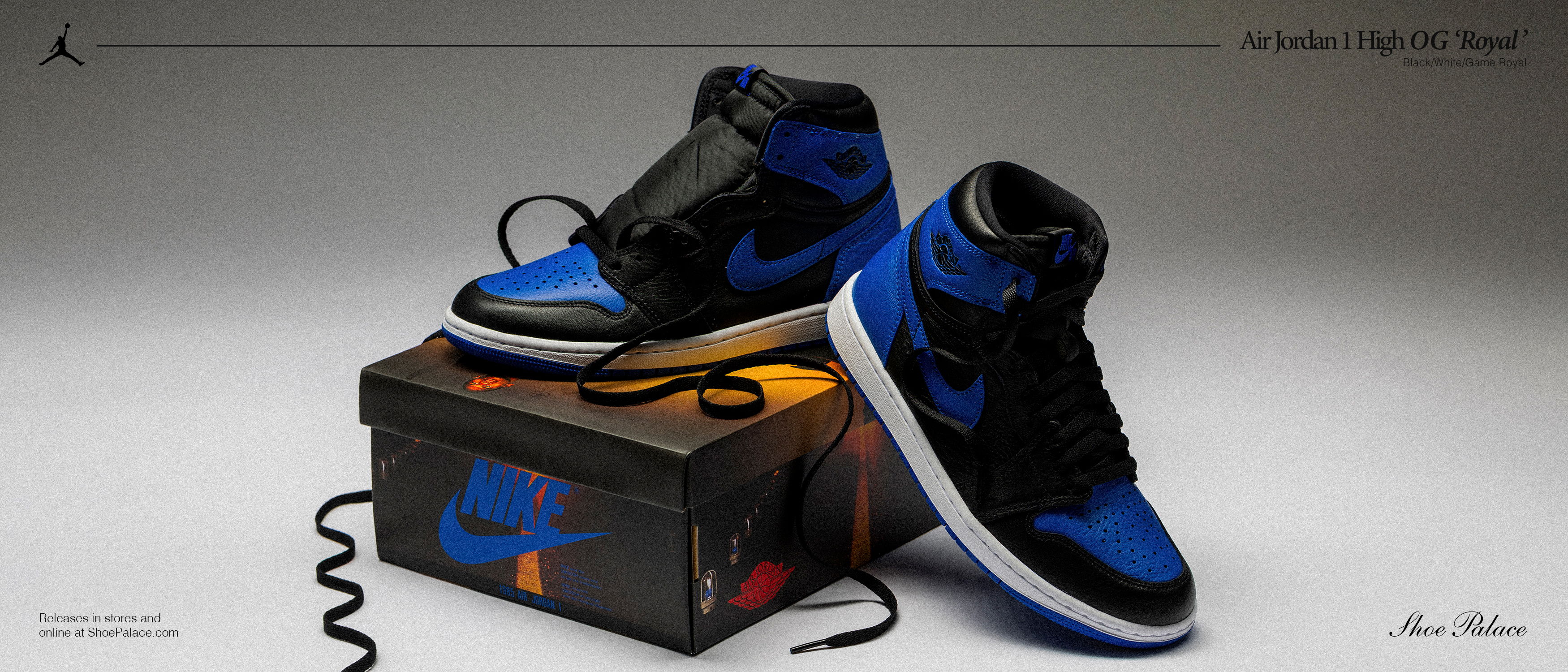 A pair of blue and black Nike sneakers on a shoe box.