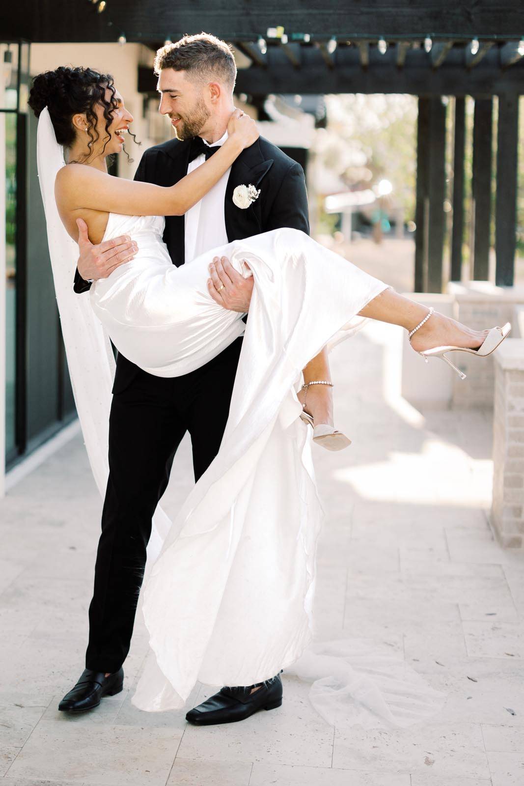 The groom lifting his bride in his arms