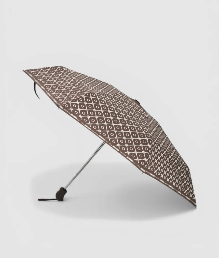 Brown patterned umbrella with a silver handle, partially open.