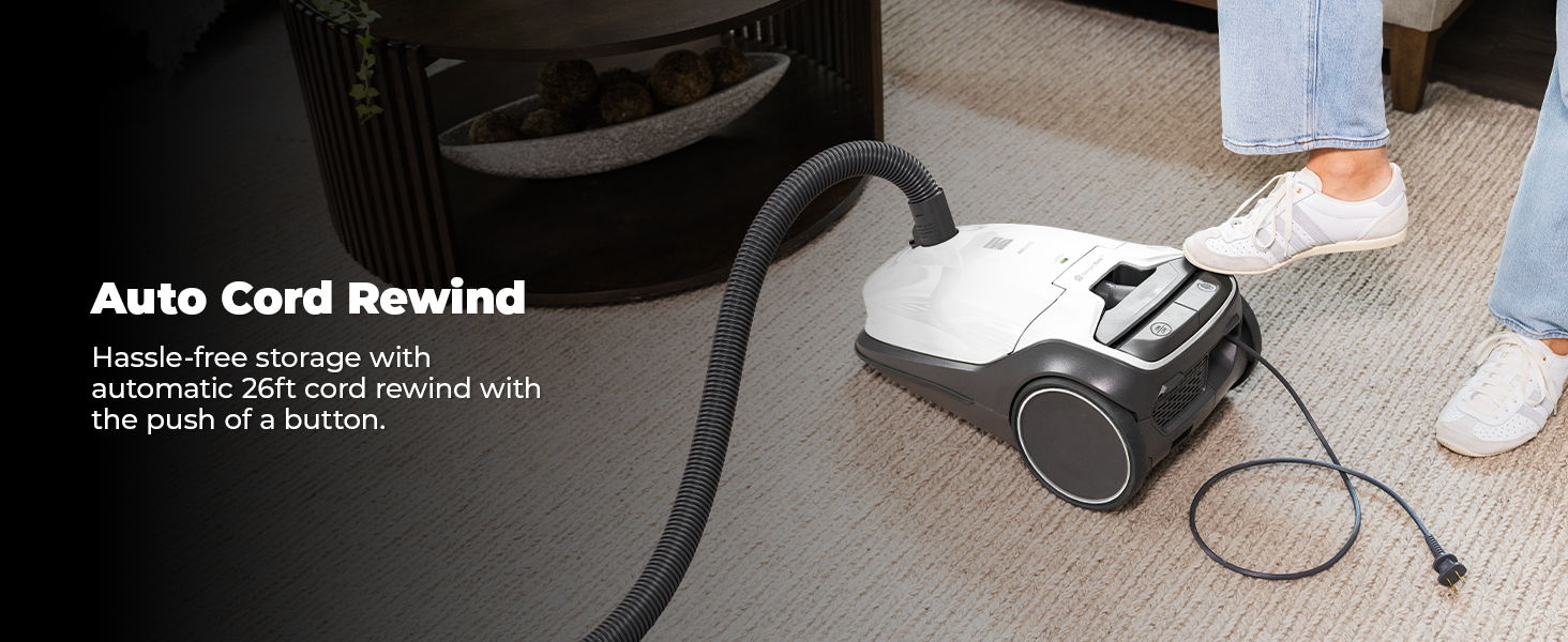Vacuum cleaner with auto cord rewind feature in use.