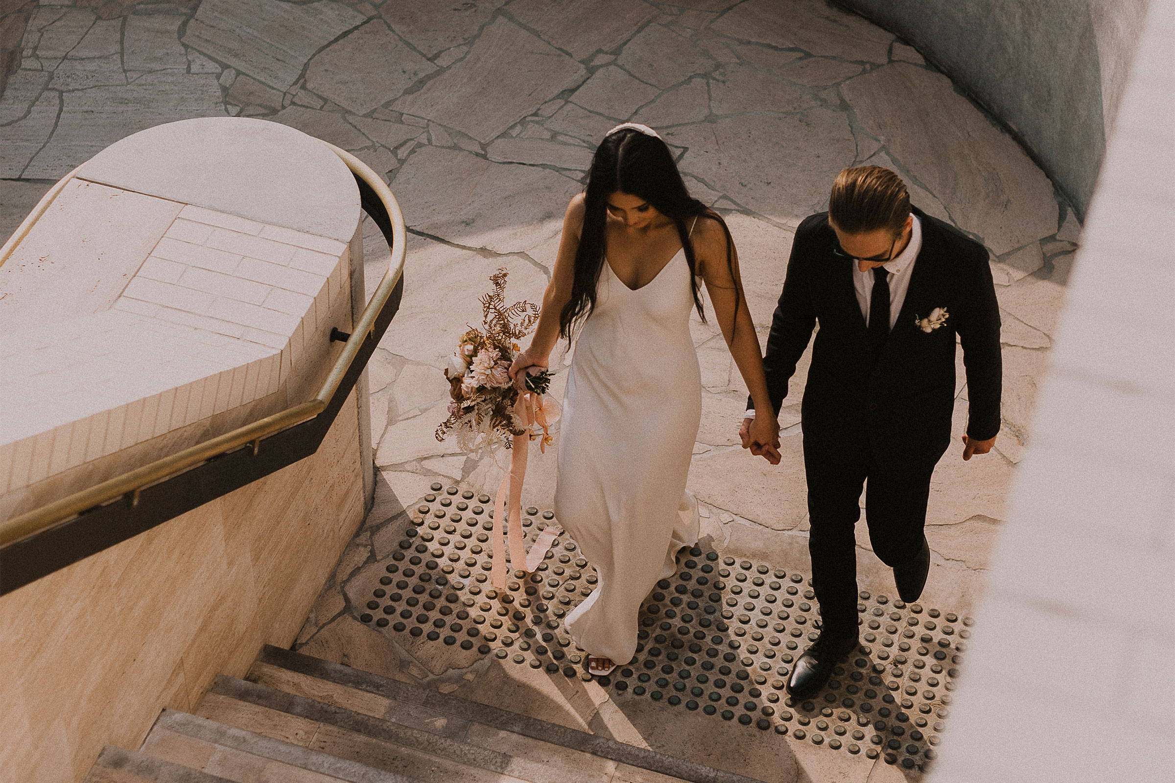 Grace Loves Lace bride wearing the Arlo gown walking with her groom